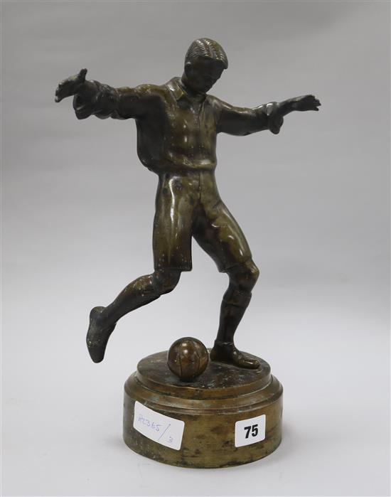 A bronze figure of a footballer